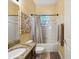Bright bathroom features granite countertops, a shower-tub combo, and neutral decor at 4481 Birchfield Loop, Spring Hill, FL 34609