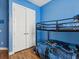 Bright bedroom with hardwood flooring, bunk beds, and a closet at 4481 Birchfield Loop, Spring Hill, FL 34609