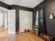 Charming bedroom with dark-themed decor, hardwood floors, closet and natural light at 4481 Birchfield Loop, Spring Hill, FL 34609