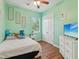 Comfortable bedroom with a window view, ceiling fan, and a TV for entertainment at 4481 Birchfield Loop, Spring Hill, FL 34609