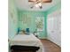 Bright bedroom with mint green walls featuring plush accents, a ceiling fan, and ample natural light at 4481 Birchfield Loop, Spring Hill, FL 34609