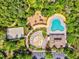 Aerial view of community amenities including a pool, splash pad, playground, and volleyball court with ample parking at 4481 Birchfield Loop, Spring Hill, FL 34609