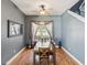 Traditional dining room features hardwood floors, modern ceiling fan, and natural light from the window at 4481 Birchfield Loop, Spring Hill, FL 34609