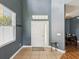 Bright foyer with tile flooring, transom window, and views into the dining area at 4481 Birchfield Loop, Spring Hill, FL 34609