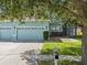 Inviting exterior showcasing a three-car garage, lush lawn, and well-maintained landscaping at 4481 Birchfield Loop, Spring Hill, FL 34609