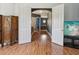 Hallway with gray walls, white trim, and hardwood floors leading to additional rooms at 4481 Birchfield Loop, Spring Hill, FL 34609