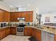 Well-equipped kitchen featuring stainless steel appliances and stylish granite countertops at 4481 Birchfield Loop, Spring Hill, FL 34609
