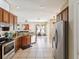 Open kitchen view into the living area, featuring stainless appliances and tile floors at 4481 Birchfield Loop, Spring Hill, FL 34609