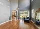 Expansive living room featuring wood floors, a high ceiling, and sliding glass doors to the backyard at 4481 Birchfield Loop, Spring Hill, FL 34609