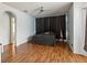 Spacious main bedroom features wood floors, a ceiling fan and an arched entry to an attached bathroom at 4481 Birchfield Loop, Spring Hill, FL 34609