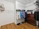 Large walk-in closet with wood floors and wire shelving for organizing clothes, shoes, and other items at 4481 Birchfield Loop, Spring Hill, FL 34609