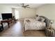 Comfortable bedroom featuring wood-look floors, neutral colors, and a ceiling fan at 4702 Portland Manor Dr, New Port Richey, FL 34655