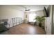 Bright bedroom with wood-look floors, a ceiling fan, and natural light from the window at 4702 Portland Manor Dr, New Port Richey, FL 34655