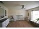 Bright bedroom with wood-look floors, a ceiling fan, and natural light from the window at 4702 Portland Manor Dr, New Port Richey, FL 34655
