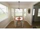 Bright breakfast nook with bay window, chandelier and comfortable seating at 4702 Portland Manor Dr, New Port Richey, FL 34655