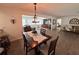 Cozy dining area featuring wood floors, an elegant chandelier, and an open floorplan at 4702 Portland Manor Dr, New Port Richey, FL 34655
