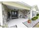 Inviting front porch with stone accents, tiled floor, and seating perfect for enjoying the outdoors at 4702 Portland Manor Dr, New Port Richey, FL 34655