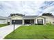 Charming single-story home with a well-manicured lawn, stone accents, and a two-car garage at 4702 Portland Manor Dr, New Port Richey, FL 34655