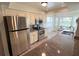 Bright kitchen featuring stainless steel appliances and a sunlit dining nook at 4702 Portland Manor Dr, New Port Richey, FL 34655