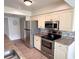 Modern kitchen with stainless steel appliances and ample cabinet space at 4702 Portland Manor Dr, New Port Richey, FL 34655