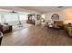 Spacious living room featuring wood-look floors, neutral decor, and an open layout ideal for entertaining guests at 4702 Portland Manor Dr, New Port Richey, FL 34655