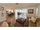 Open-concept living room featuring wood-look floors, neutral tones, and seamless flow to dining and kitchen areas at 4702 Portland Manor Dr, New Port Richey, FL 34655