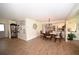 Open living and dining space with wood-look floors and neutral tones, perfect for gatherings and Gathering meals at 4702 Portland Manor Dr, New Port Richey, FL 34655