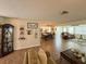 Inviting living room with wood-look floors and neutral tones, seamlessly connecting the living, dining, and kitchen spaces at 4702 Portland Manor Dr, New Port Richey, FL 34655
