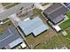 The property is seen in an aerial view, highlighting the roof's condition, lot size, and proximity to neighboring residences at 5321 Mosaic Dr, Holiday, FL 34690