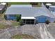 Aerial view of home with a well-maintained roof, screened in porch, and mature landscaping at 5321 Mosaic Dr, Holiday, FL 34690