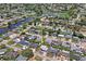 A bird's-eye view showcases the property’s position in a waterside community with nearby canals and lush landscaping at 5321 Mosaic Dr, Holiday, FL 34690