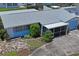 Overhead view of a home with a screened in porch, driveway, and mature trees at 5321 Mosaic Dr, Holiday, FL 34690