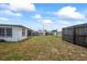 Backyard has a wooden fence and a shed in the distance at 5321 Mosaic Dr, Holiday, FL 34690