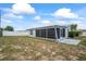 A long shot of the backyard, with a screened in porch attached to the home at 5321 Mosaic Dr, Holiday, FL 34690
