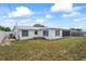 The backyard of the home, showing a screened in porch attached to the home at 5321 Mosaic Dr, Holiday, FL 34690