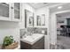 Bathroom featuring a gray vanity, mirror, decorative accents, and view to bedroom and shower at 5321 Mosaic Dr, Holiday, FL 34690