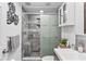 Modern bathroom featuring a glass-enclosed shower with bench, neutral tile, and stylish fixtures at 5321 Mosaic Dr, Holiday, FL 34690