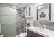 Modern bathroom showcasing a glass-enclosed shower, neutral tile, modern vanity and stylish accents at 5321 Mosaic Dr, Holiday, FL 34690
