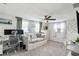 Bedroom with a daybed, ceiling fan, decorative curtains, large windows, and a dedicated desk and workspace at 5321 Mosaic Dr, Holiday, FL 34690
