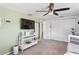 Bedroom with white shelving unit, mounted television, accent walls, and closet with bi-fold doors at 5321 Mosaic Dr, Holiday, FL 34690