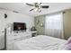 Bedroom with white furniture, modern fan and lighting, and vanity space in front of large window at 5321 Mosaic Dr, Holiday, FL 34690
