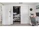 Bedroom closet featuring organized shelving and clothes rack, with view to desk at 5321 Mosaic Dr, Holiday, FL 34690