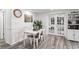 Bright dining room boasts wood-look flooring, stylish lighting, and ample space for entertaining at 5321 Mosaic Dr, Holiday, FL 34690