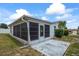 A screened in porch with a small concrete patio in the backyard of the home at 5321 Mosaic Dr, Holiday, FL 34690