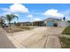 Exterior view of the home showcasing its landscaping, driveway, and serene neighborhood at 5321 Mosaic Dr, Holiday, FL 34690