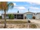 Charming single-story home featuring a screened-in porch and a delightful light blue garage door at 5321 Mosaic Dr, Holiday, FL 34690
