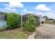 Lush greenery surrounds the screened in porch, adding privacy to the home's exterior at 5321 Mosaic Dr, Holiday, FL 34690