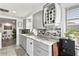 Charming kitchen with granite countertops, wine rack and updated white cabinetry and stainless steel appliances at 5321 Mosaic Dr, Holiday, FL 34690