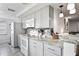 Updated kitchen showcases white appliances, gray cabinets, granite countertops, and stylish backsplash at 5321 Mosaic Dr, Holiday, FL 34690