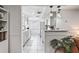 Bright kitchen featuring granite countertops, white cabinetry, tile floors, and modern pendant lighting at 5321 Mosaic Dr, Holiday, FL 34690